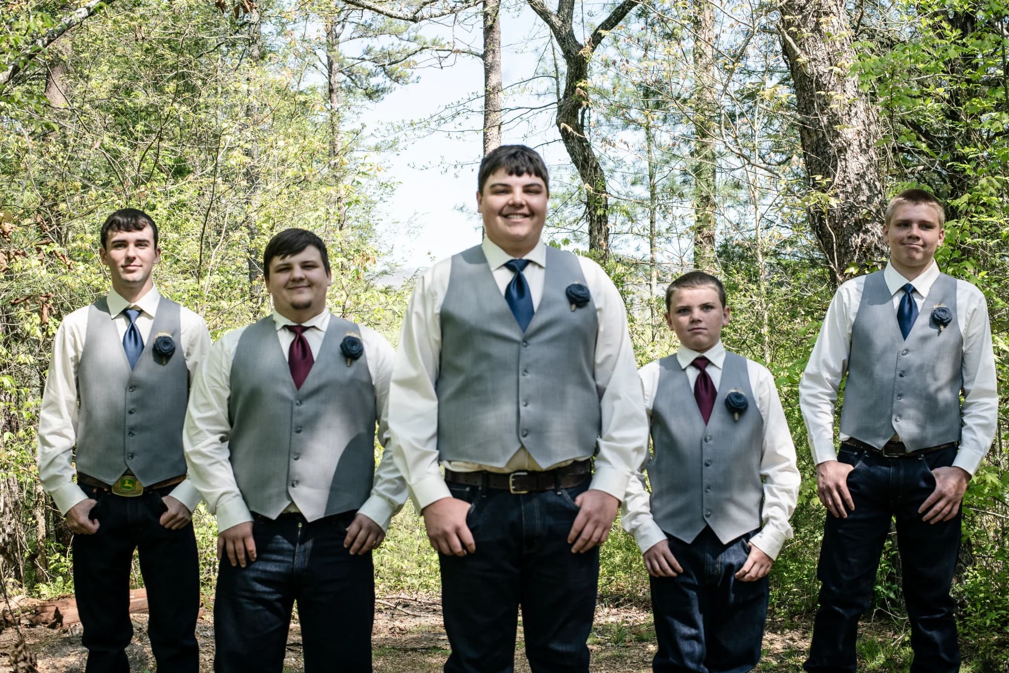 Groomsmen posing in a wooded outdoor setting near the Smoky Mountains at Moose Hollow Lodge in Pigeon Forge