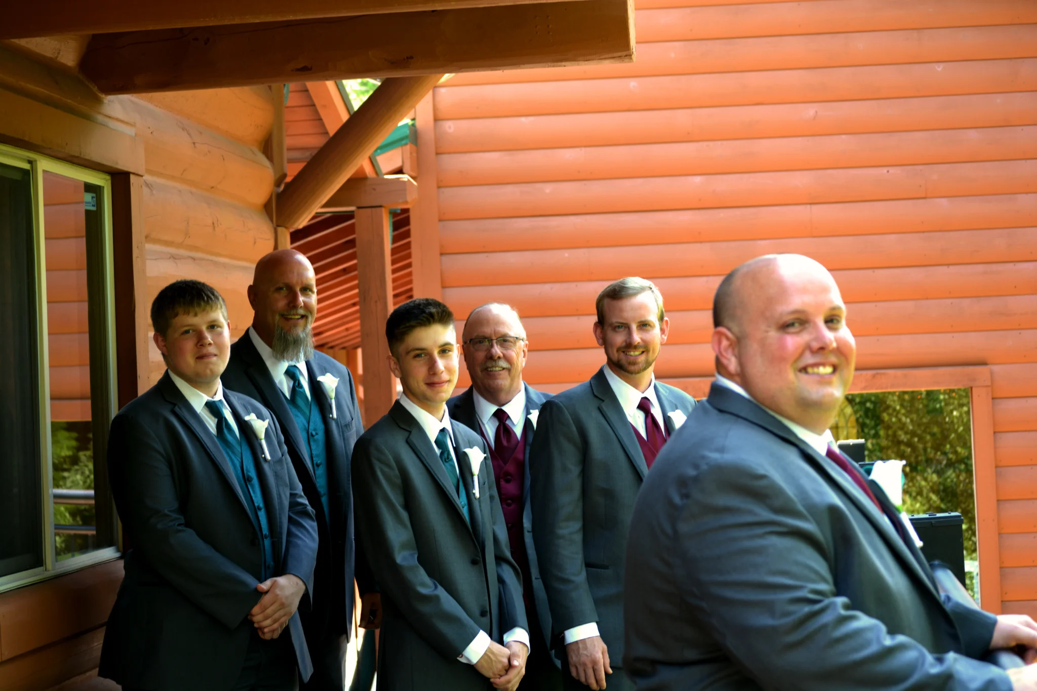 Groomsmen on a rustic log cabin porch for a wedding at Moose Hollow Lodge near Smoky Mountains in Pigeon Forge