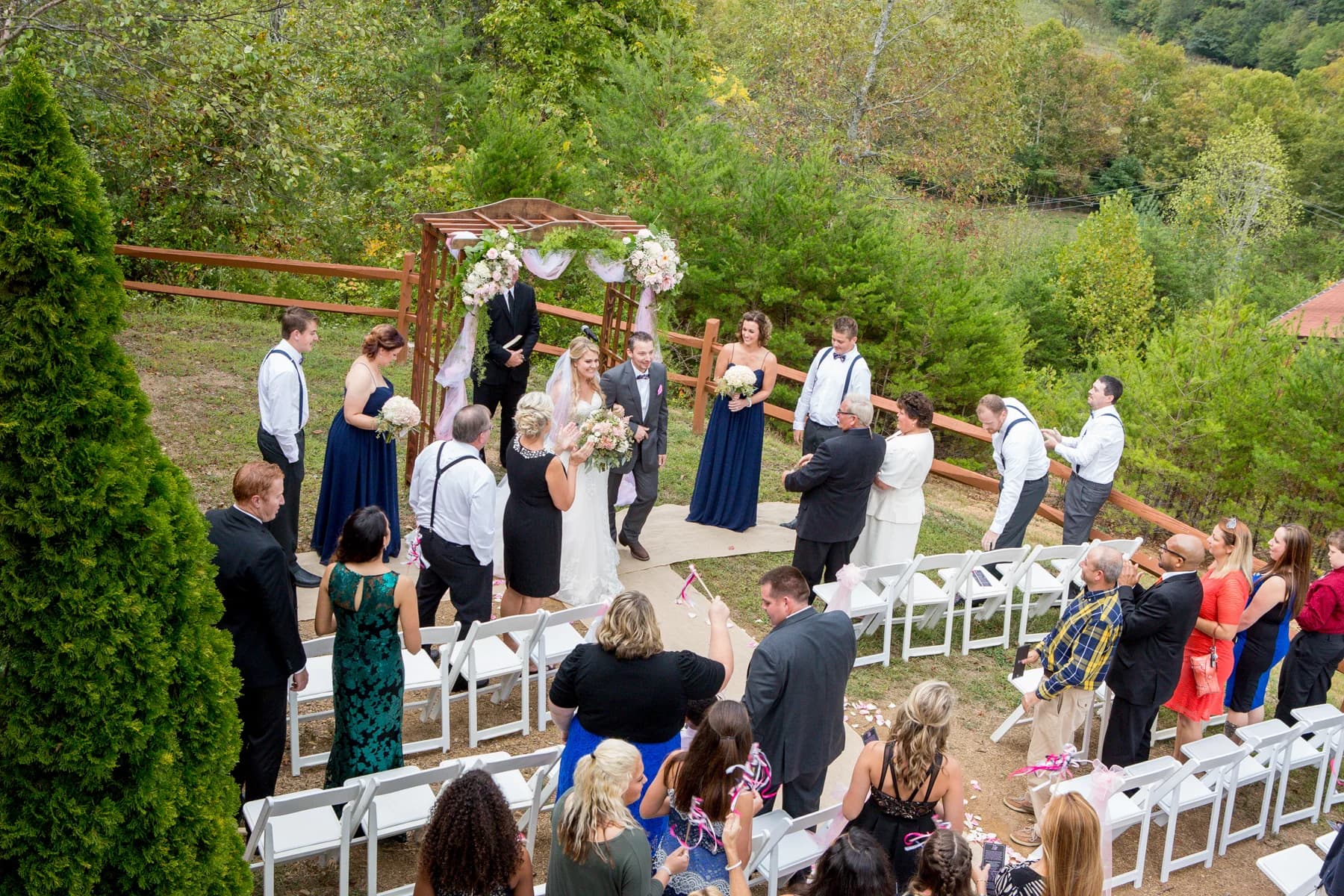 Outdoor wedding ceremony under floral arbor with mountain views at Moose Hollow Lodge in Pigeon Forge near Smoky Mountains