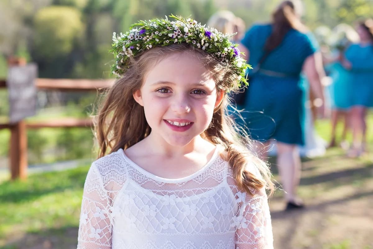Outdoor event lawn at Moose Hollow Lodge featuring a rustic wooden fence and lush green landscape under soft natural light.