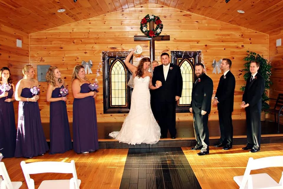 Rustic wood-paneled wedding chapel ceremony with wedding party at Moose Hollow Lodge in Pigeon Forge