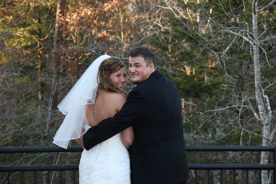 Newlyweds on a deck with forest views near Dollywood at Moose Hollow Lodge in Pigeon Forge