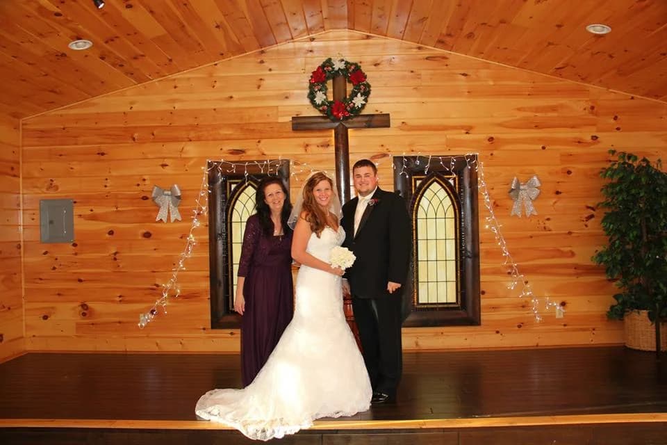 Bride and groom in a rustic wood-paneled wedding chapel at Moose Hollow Lodge in Pigeon Forge