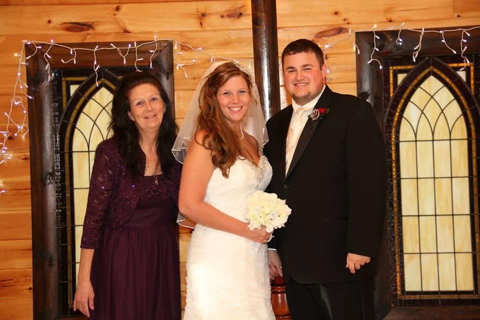 Rustic indoor wedding ceremony space with wood walls and arched windows at Moose Hollow Lodge in Pigeon Forge