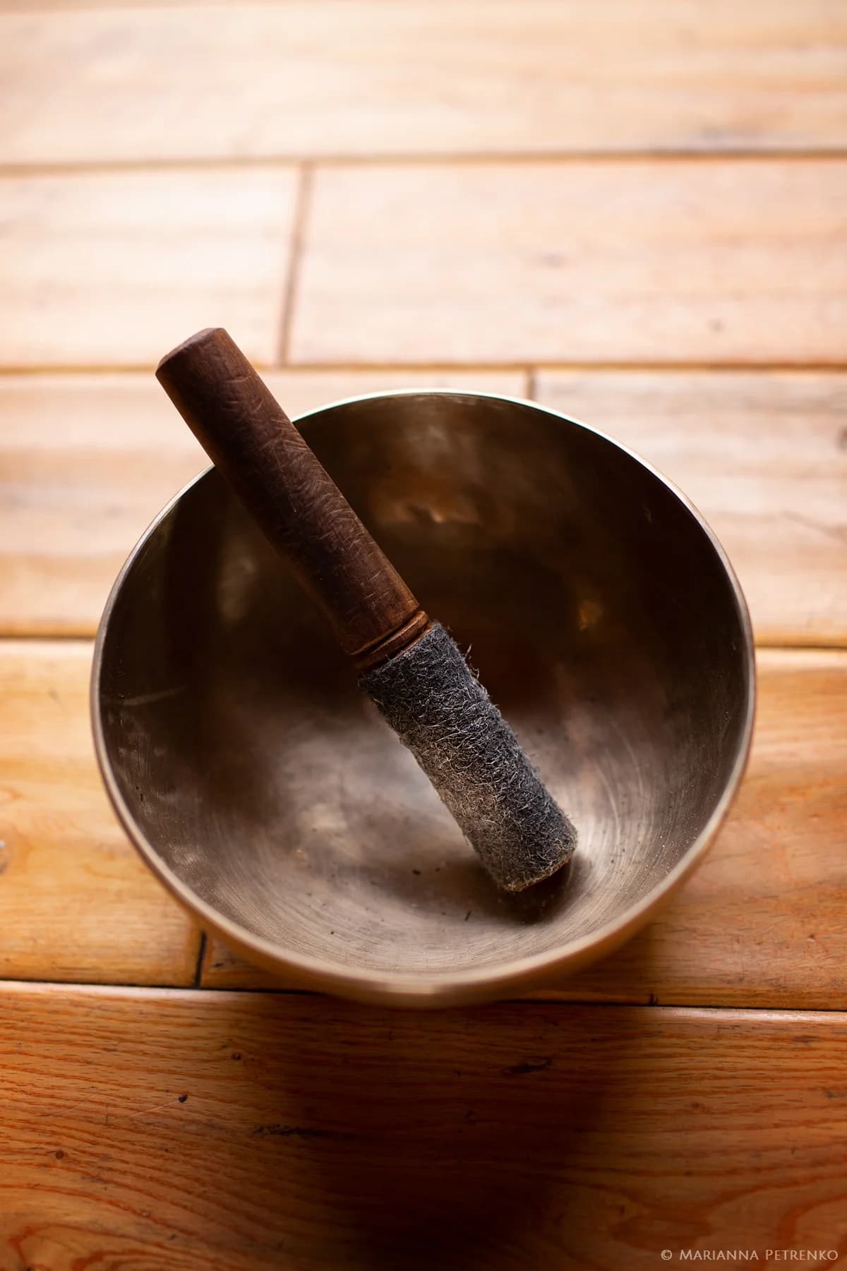 Warm wooden flooring and a carefully placed bronze singing bowl evoke tranquility at Moose Hollow Lodge.