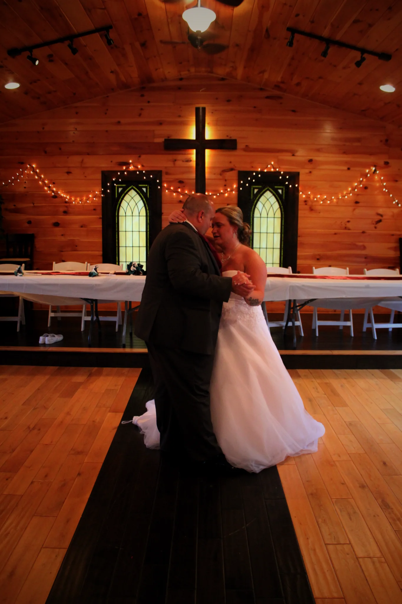 Couple dancing in a rustic wooden chapel wedding venue at Moose Hollow Lodge in Pigeon Forge