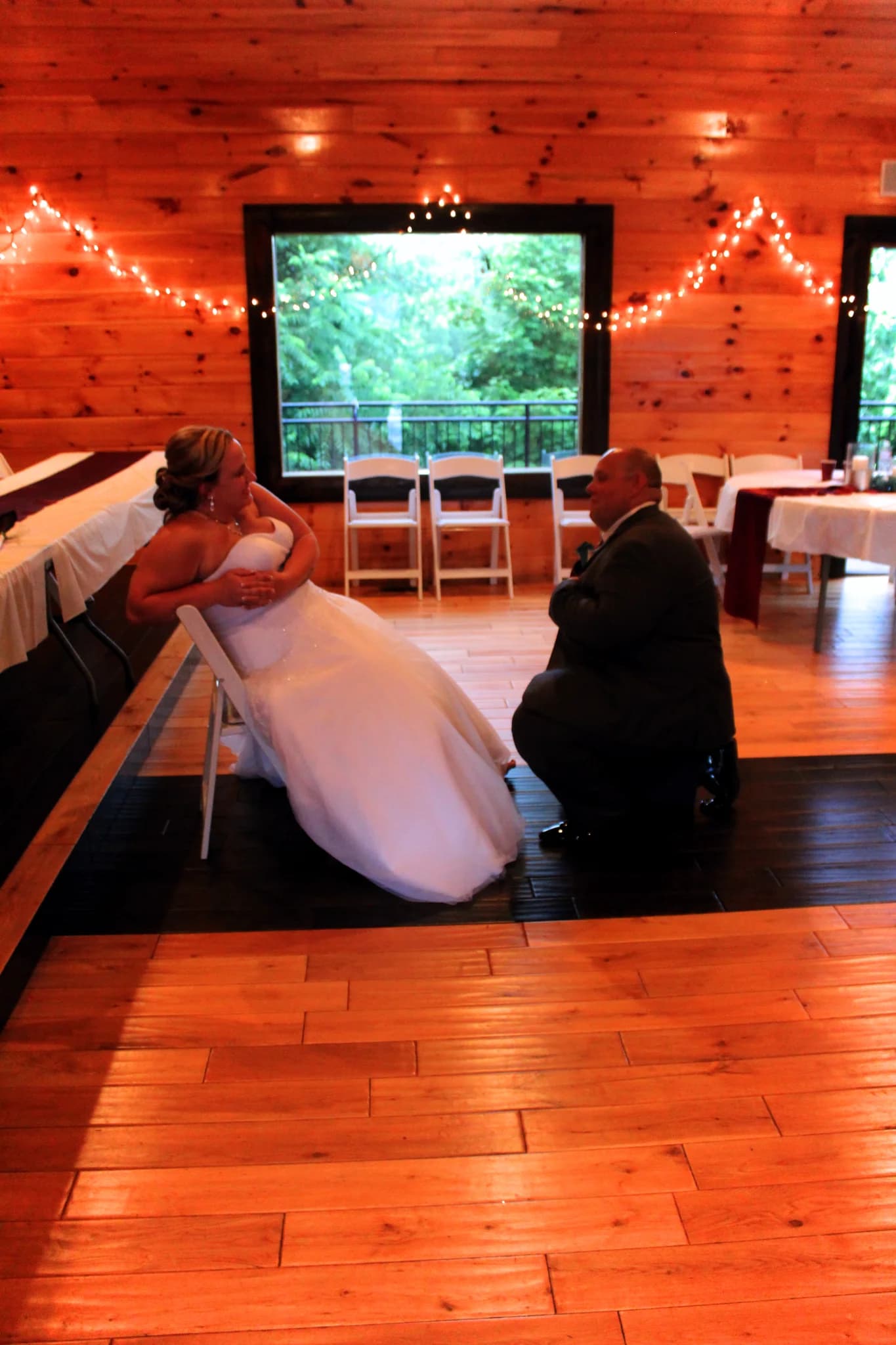 Rustic wedding reception hall with wood-paneled walls and string lights at Moose Hollow Lodge in Pigeon Forge
