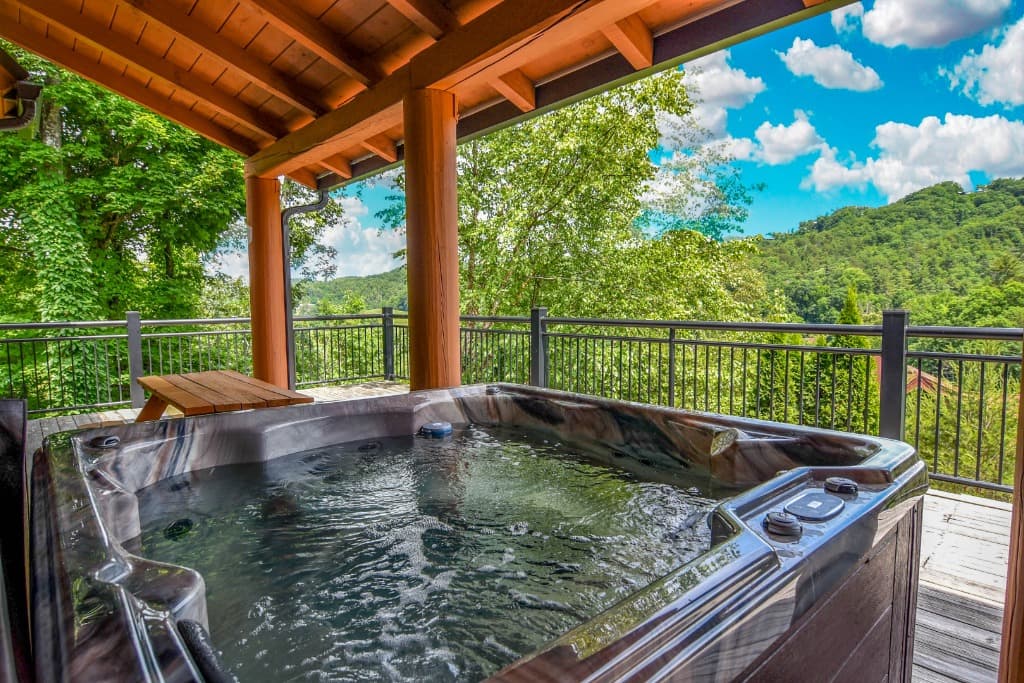Hot tub on covered deck with Smoky Mountain views near Dollywood at Moose Hollow Lodge in Sevierville