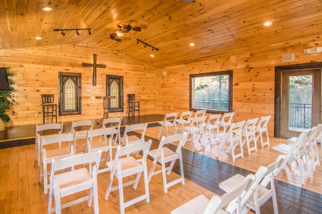 Chapel ceremony space with stained glass windows and altar