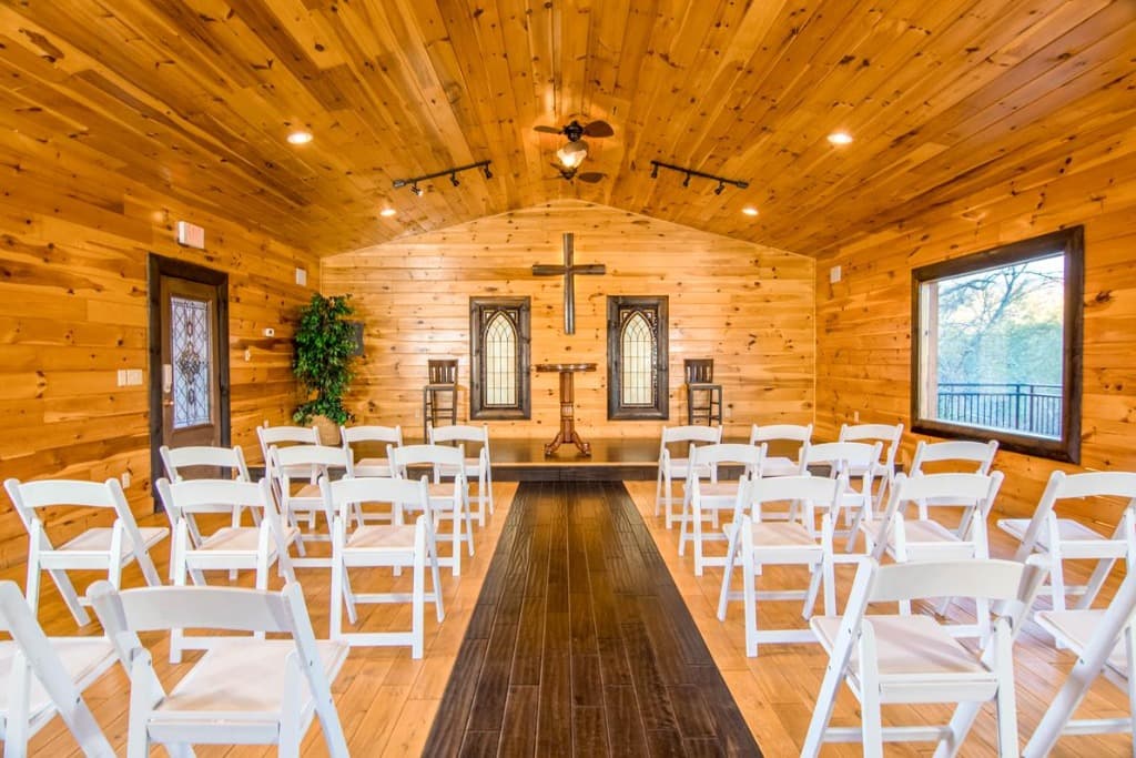Chapel aisle view with cross and ceremony seating