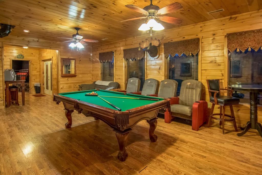 Spacious game room with pool table and theater seating at Moose Hollow Lodge in Sevierville