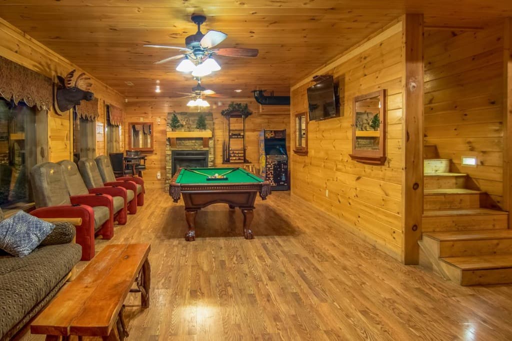 Spacious game room with pool table, arcade, and theater seating at Moose Hollow Lodge in Sevierville